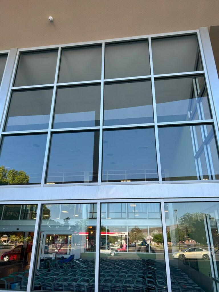 Two-story glass entryway at a retail store after commercial window washing