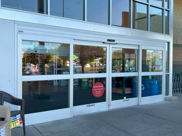 Storefront entrance with freshly washed glass doors and transom windows