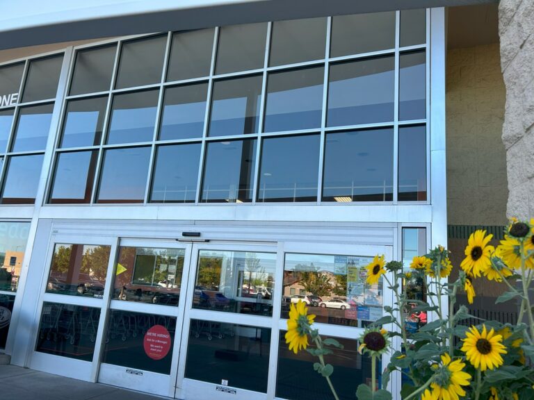 Clean glass storefront and automatic doors at a retail store