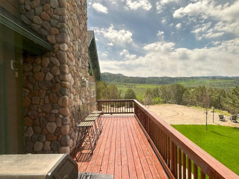 Clear view of a wraparound deck and valley through freshly washed windows