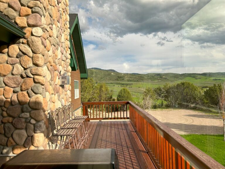 Stone home and deck with sparkling clean windows overlooking the countryside