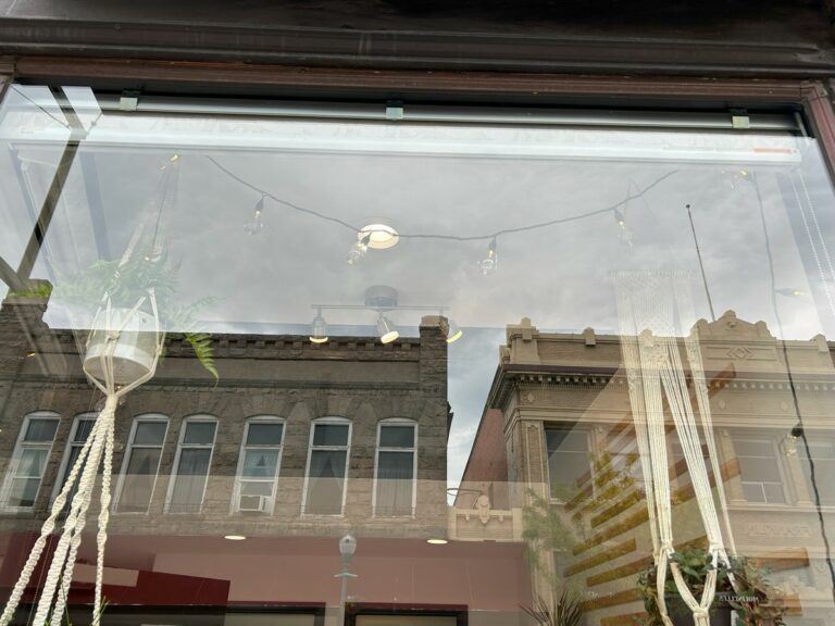 Large downtown storefront display window after washing